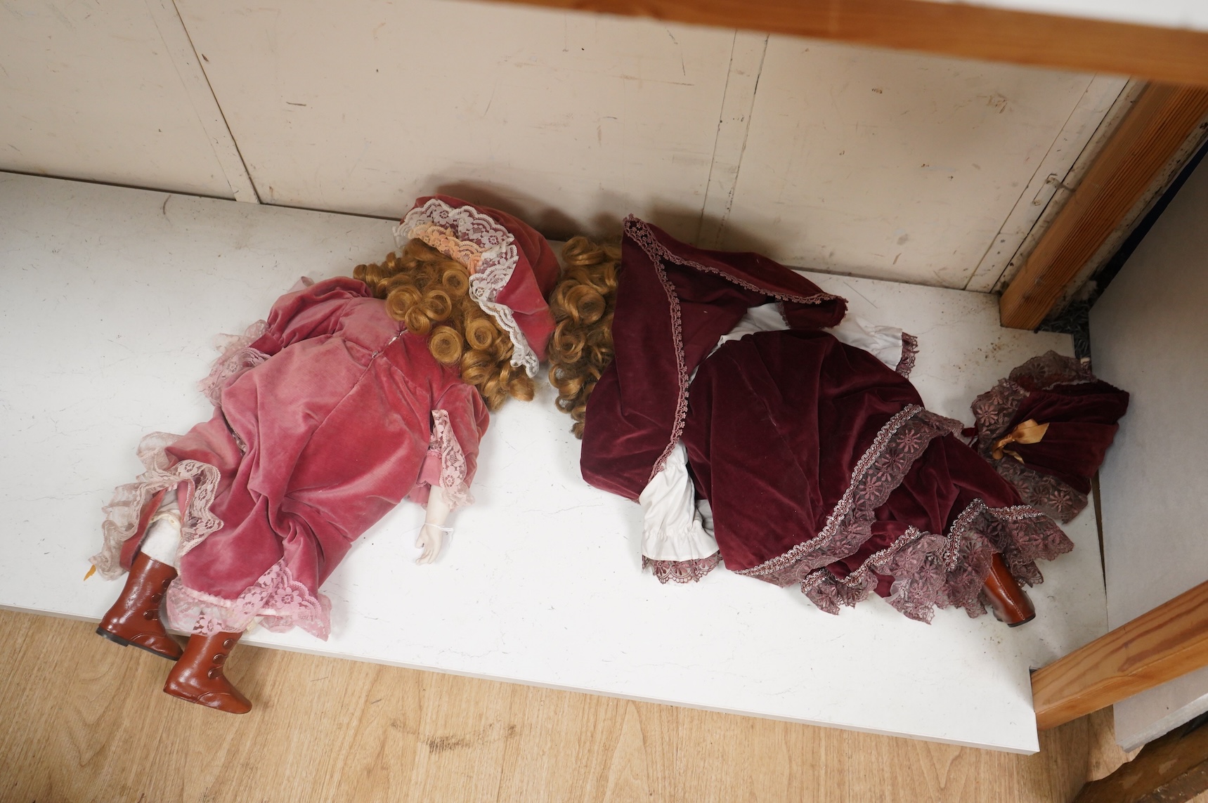 Two bisque dolls in matching Victorian clothing, 60cm high